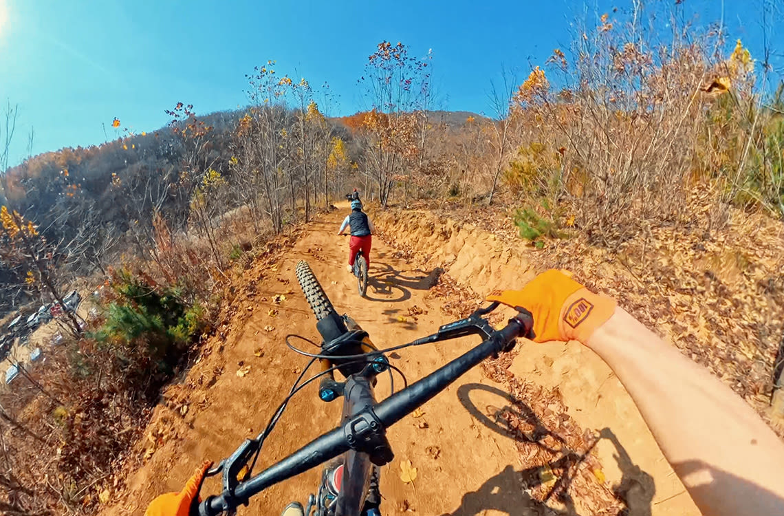 Mountain bikers following local riders down one of the several trails.