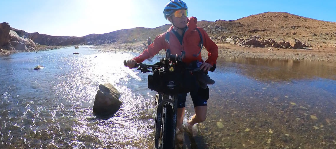 Josh Reid crosses a river with his Anthem Advanced Pro 29 at the Altas Mountain Race in Africa. 