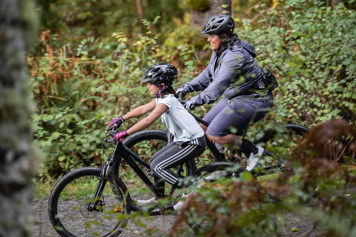 a woman riding mountain bikes with her daughter