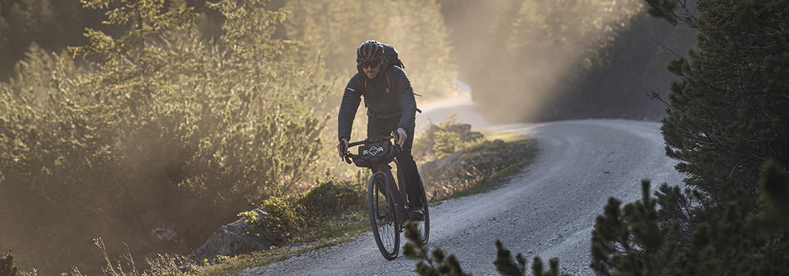 image of a man riding the giant revolt electric bike down a bike path