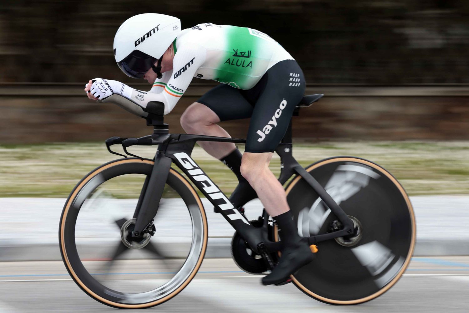 A Jayco Alula pro cyclist rides a Giant Trinity Advanced on hte opem roads with a Giant Rivet Mips helmet.