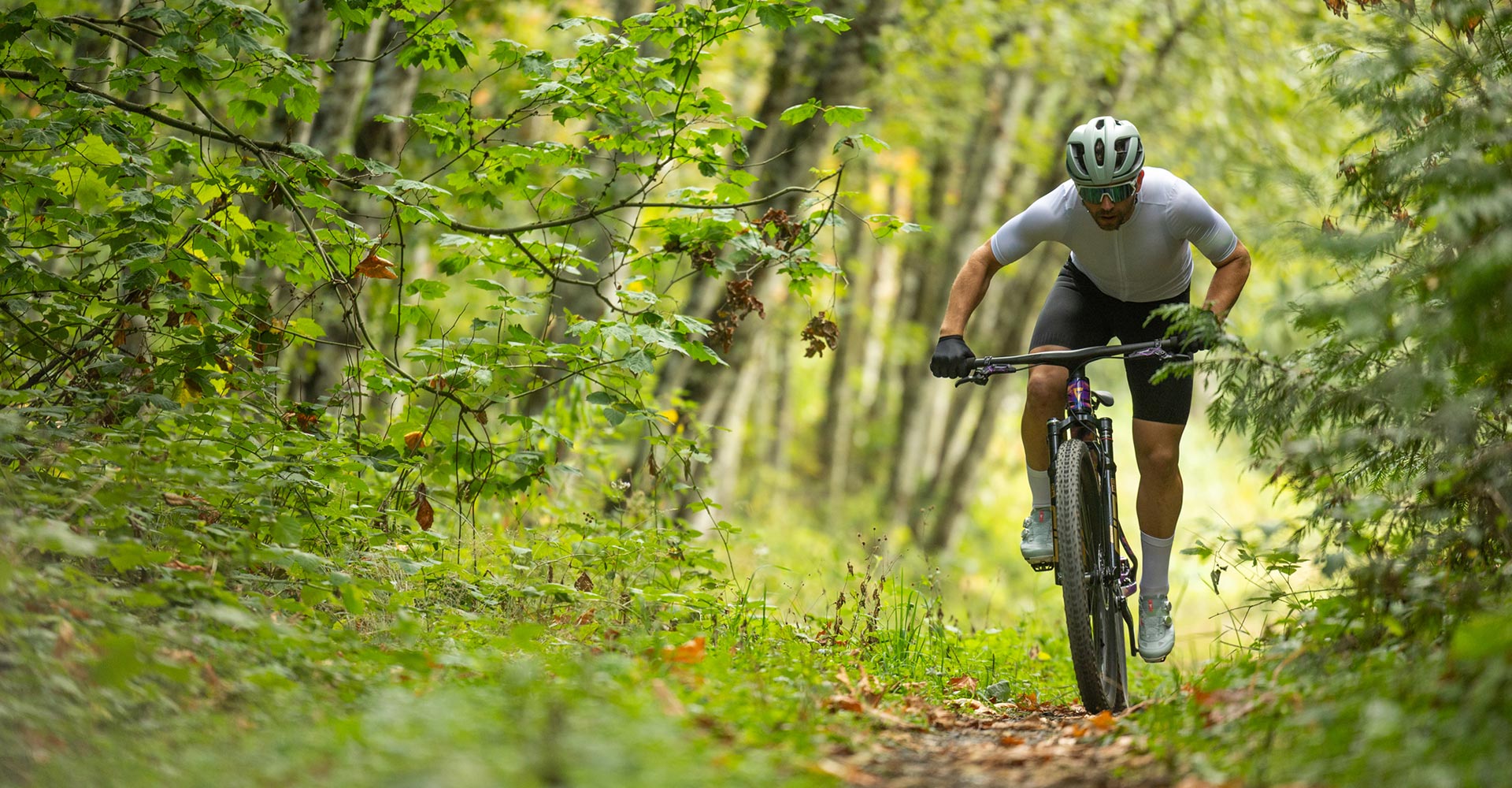 XC rider sprinting on trail