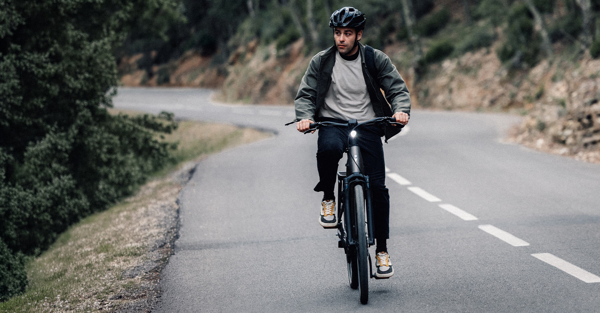 Guy riding Anytour E+ electric bike