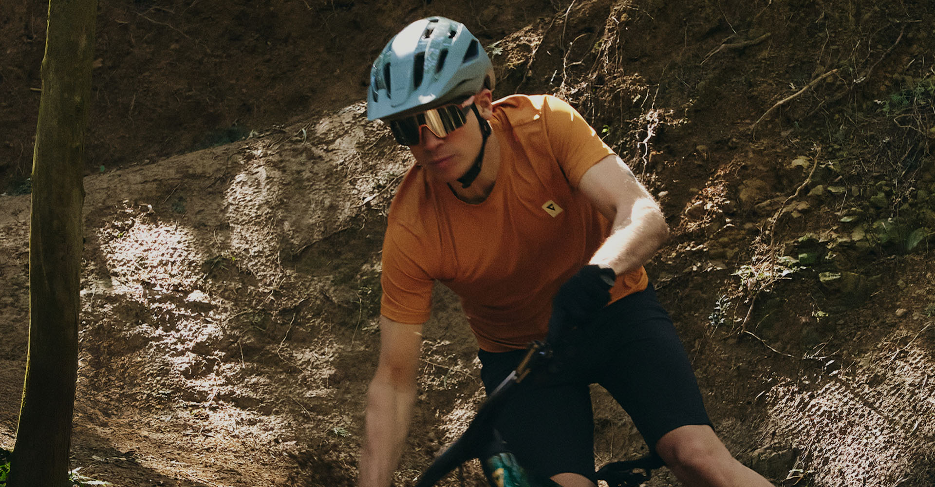 mountain biker riding full suspension bike with helmet and sunglasses