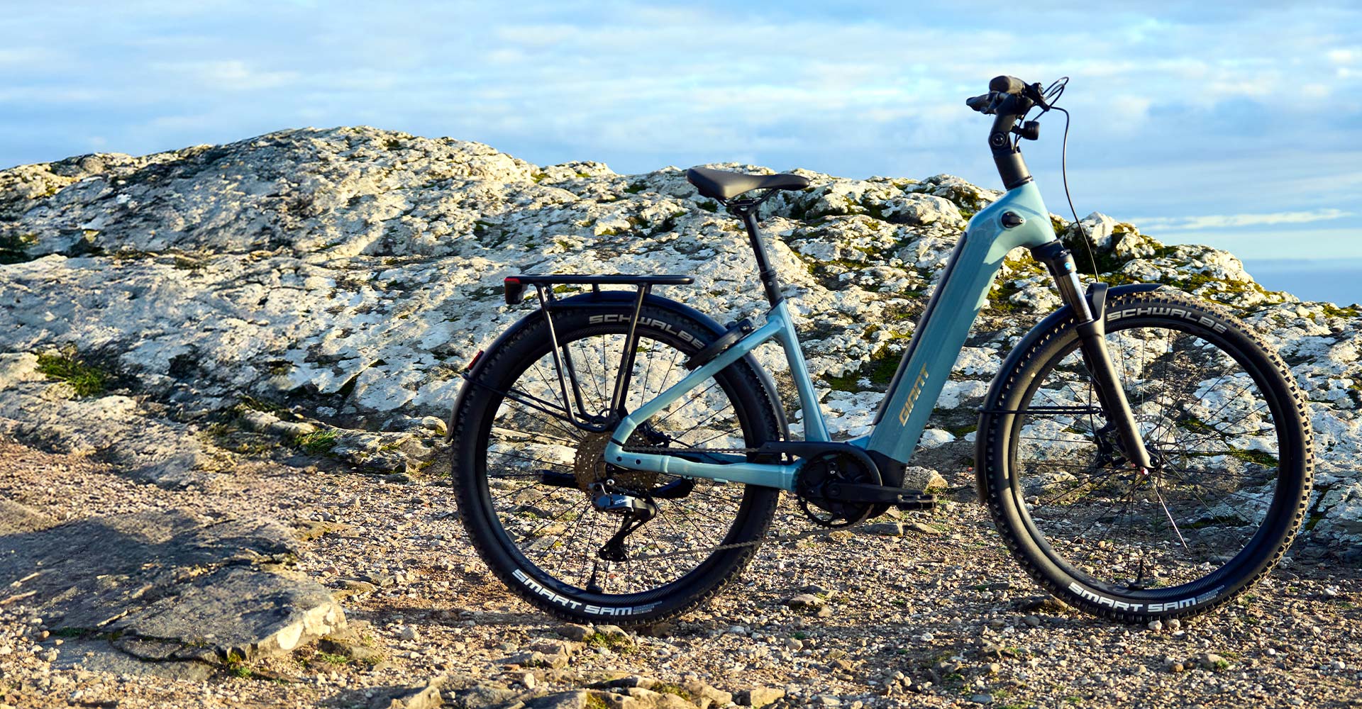 AnyTour X E+ electric bike leaned on kickstand on dirt trail