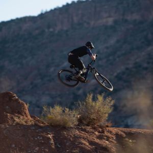 E-MTB being jumped off a jump trail line