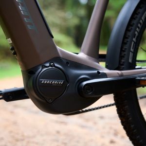 A close up look at the motor on the non-drive side of the Giant AnyTour X E+ in the forest.