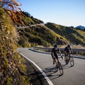 Two road cyclists ride side by side on mountain road on Giant TCR Advanced Sl 0.