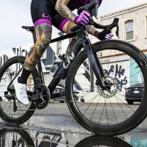 A woman riding the EnviLiv through a puddle of water. 