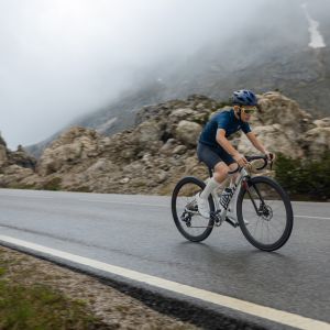 A young roadie ascends a high mountain road on a Giant Seek.