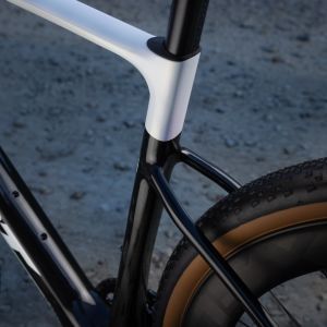 A close up look at the rear triangle and tire clearance of the Giant Revolt Advanced SL on a dirt road.