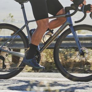 Cyclist riding Giant TCR Advanced SL out of the saddle.