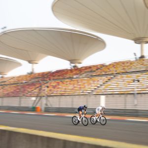 Cyclists riding at formula 1 track
