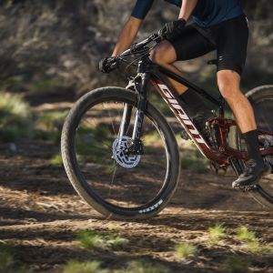 Mountain biker rides by on full suspension Giant XC bike with Crest SL fork.