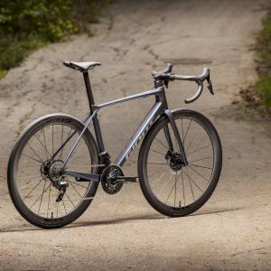 Angled profile view of Giant TCR Advanced Pro on a shaded road.