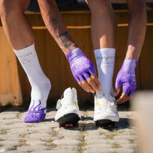 A Jayco Alula pro road rider puts on a pair of Giant Surge Pro Road bike shoes.