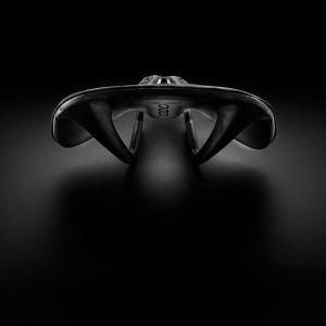 CADEX Amp 3D saddle with a stylized black background.
