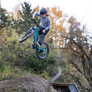 A young rider catches air off a jump on a Giant STP 20.