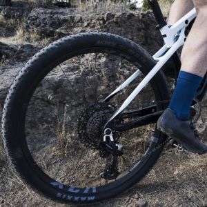 A close up view of the Giant XCA cross country mountain bike wheels on a Giant Anthem Advanced SL mountain bike riding through rocky terrain.