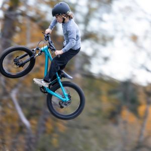 Close up image of a young rider airing it out off a jump on a Giant STP 20.