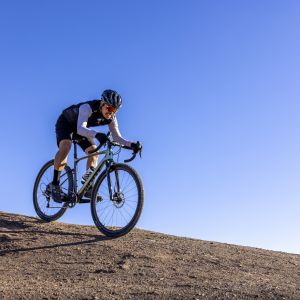 Cyclist descends gravel on Giant Crosscut Grip tires.