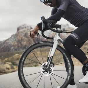 Road cyclist checks out his CADEX Max 40 wheelset.