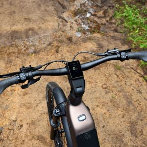 An overhead close up look of the cockpit and e bike controls of a Giant AnyTour X E+ in the forest.