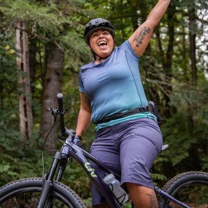 a woman yelling while standing over the Embolden mountain bike