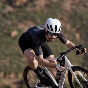 A cyclist descends riding a Giant Propel Advanced Pro wearing a Giant Pursuit helmet.