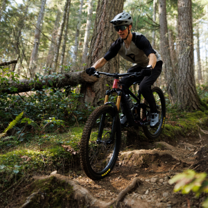 A mountain biker takes on a rooted trail wearing Giant Shuttle Flat BOA mtb shoes.