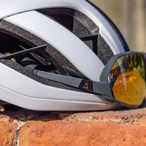 A close up look at the front of the Giant Rev pro Helmet with Giant sunglasses inserted in the frontal vents.