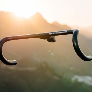 The CADEX Aero Integrated Road Handlebar floating in front of a mountain backdrop.