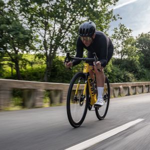 Action shot of a cyclist descending in an aero position on a Giant TCR Advanced SL legends edition frame.