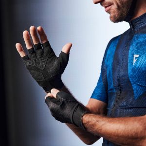 Closeup of cyclist putting on glove in studio setting