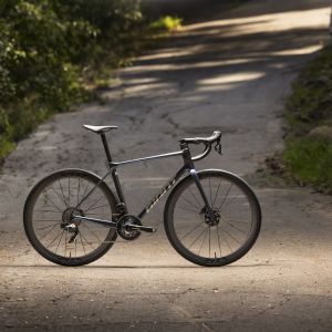 Profile view of Giant TCR Advanced Pro on shady road.
