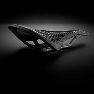 CADEX Amp 3D saddle with a stylized black background.