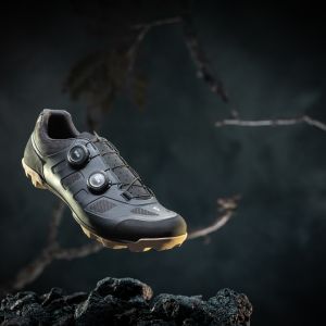 A close up look at the Giant Charge 1 gravel shoe with a stylized background.