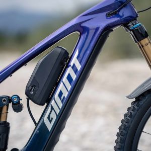 A close up view of a range extender attached to the Giant Reign Advanced E+ enduro bike with a mountain backdrop.