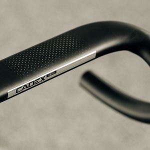 A close up view of the aero tops on the CADEX Aero Integrated Road Handlebar floating above the road.