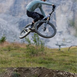 A mountain biker hits a large jump on a Giant Trance Advanced E+ with TRX HD wheels.
