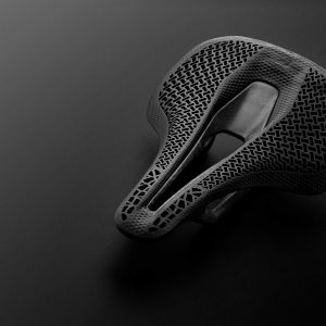 CADEX Amp 3D saddle with a stylized black background.
