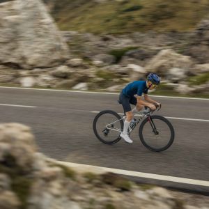 A youth road biker ascends on a road bike fitted with Giant SLR 40 1 650b wheels.