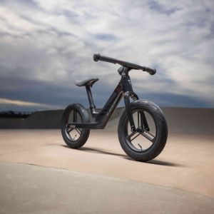 Side angle view of the Giant Pre rCarbon strider bike at a skatepark.