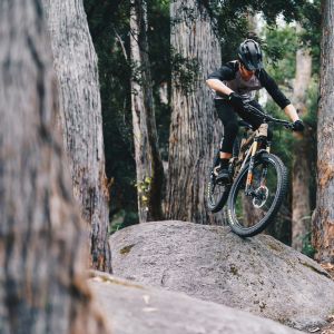 mountain biker riding over rock