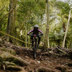 Rae riding over tree roots.