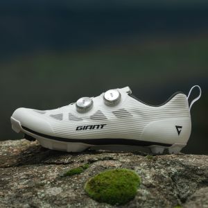 A close up look at the boa side ofthe Giant Charge Pro gravel/XC shoe on a rock.