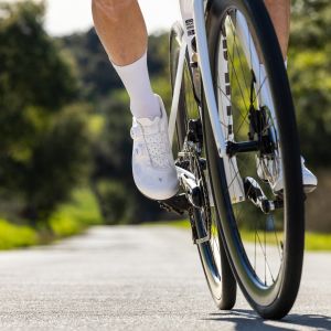 A close up look at a cyclist's feet as they approach wearing Giant Surge road bike shoes.