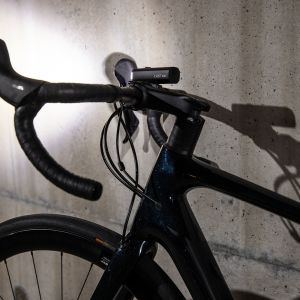 light mounted on bicycle standing against wall