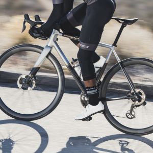 Road cyclist rides effortlessly over tarmac on CADEX Race GC tubeless tires.