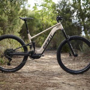 The Giant Stance E+ electric trail bike staged on a woodsy trail.